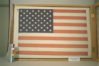 Flag flown aboard the first U.S. human spaceflight in 1961, labeled incorrectly as the "first American flag in space."