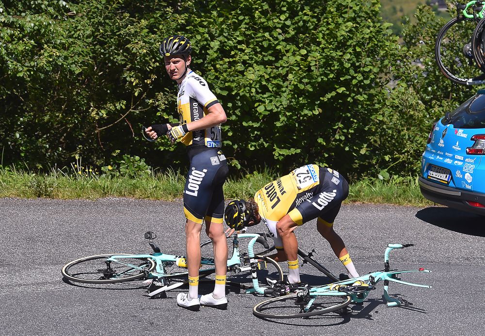 Wilco Kelderman and George Bennett wait for help from the team car during stage 8 at the Tour de France