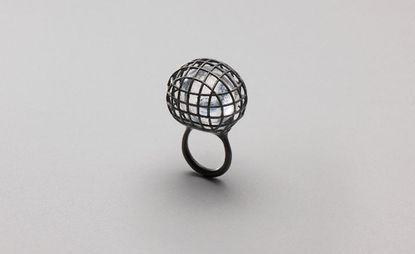 A graphite coloured, cage-esque ring