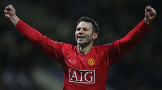 BOLTON, ENGLAND - JANUARY 17: Ryan Giggs of Manchester United celebrates Dimitar Berbatov scoring their first goal during the Barclays Premier League match between Bolton Wanderers and Manchester United at The Reebok Stadium on January 17 2009 in Bolton, England. (Photo by Matthew Peters/Manchester United via Getty Images)