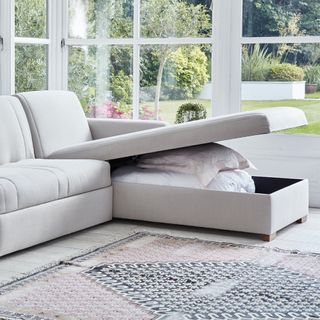 storage sofa with lid open and pillows inside