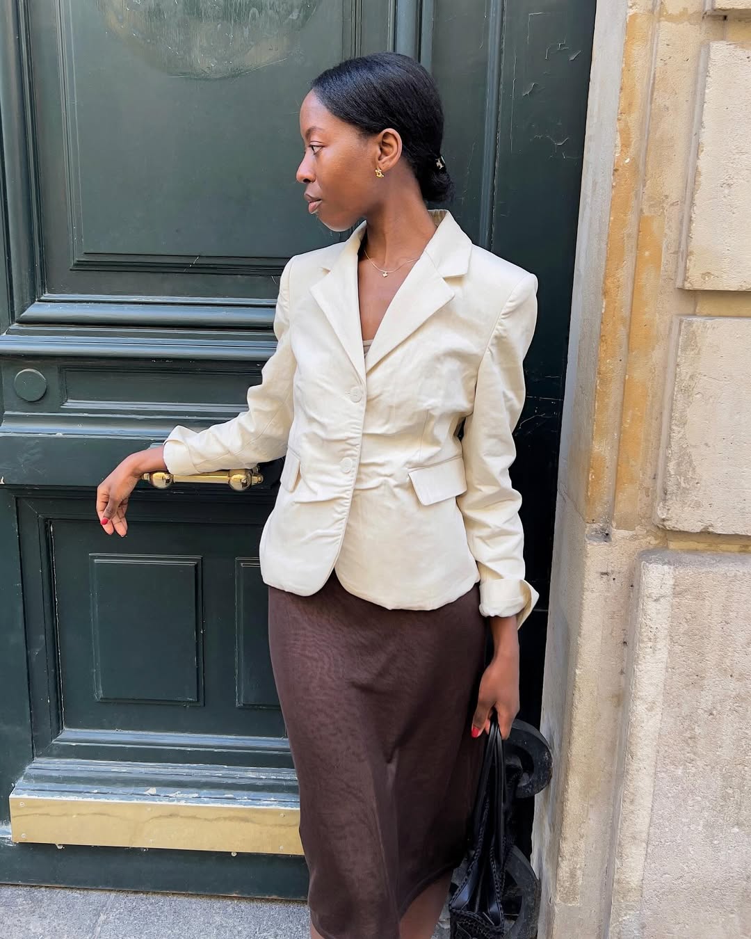 Sylvie in a ruched blazer and midi skirt
