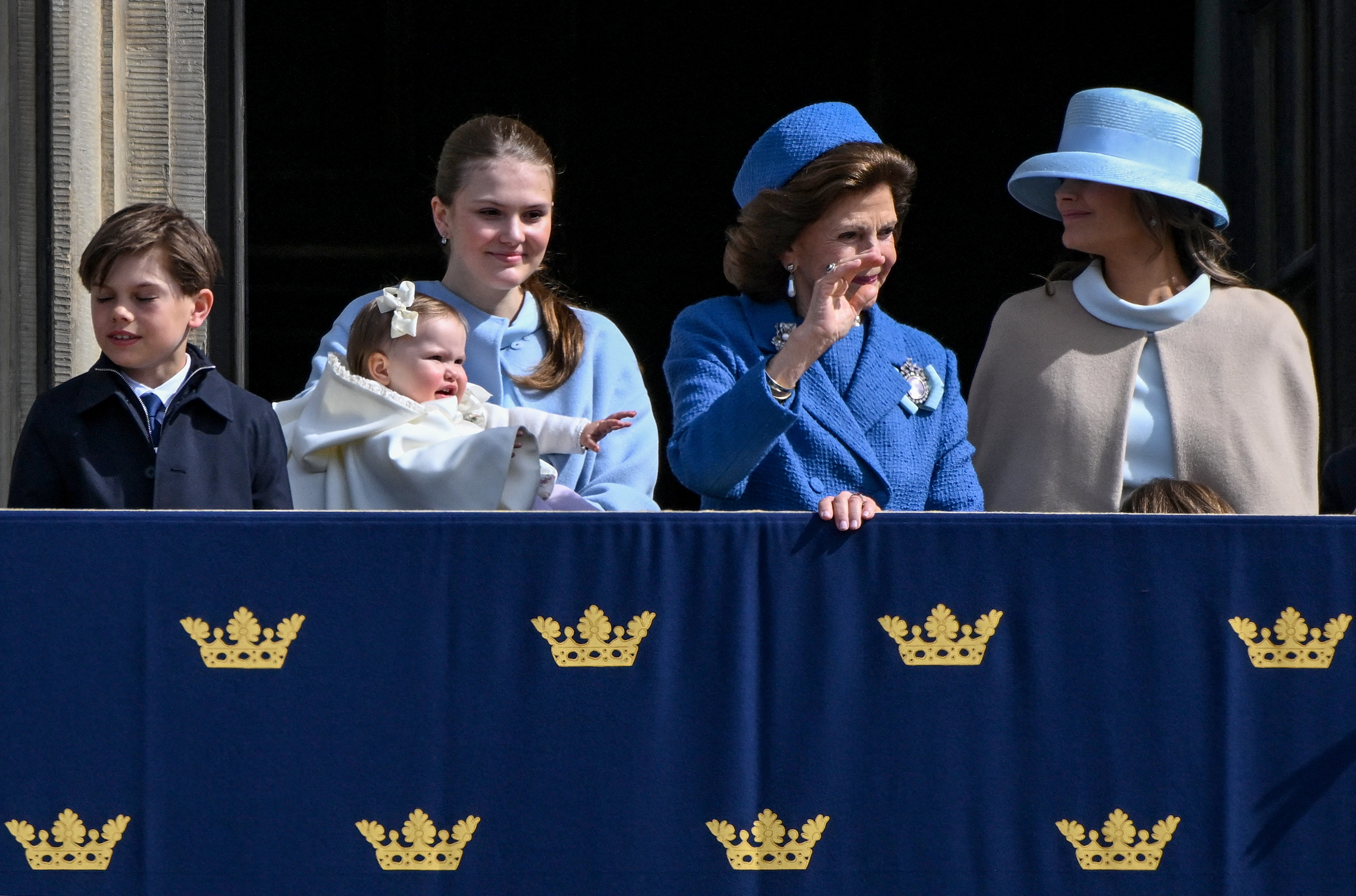 Princess Estelle holding Princess Ines next to Queen Silvia and Princess Sofia
