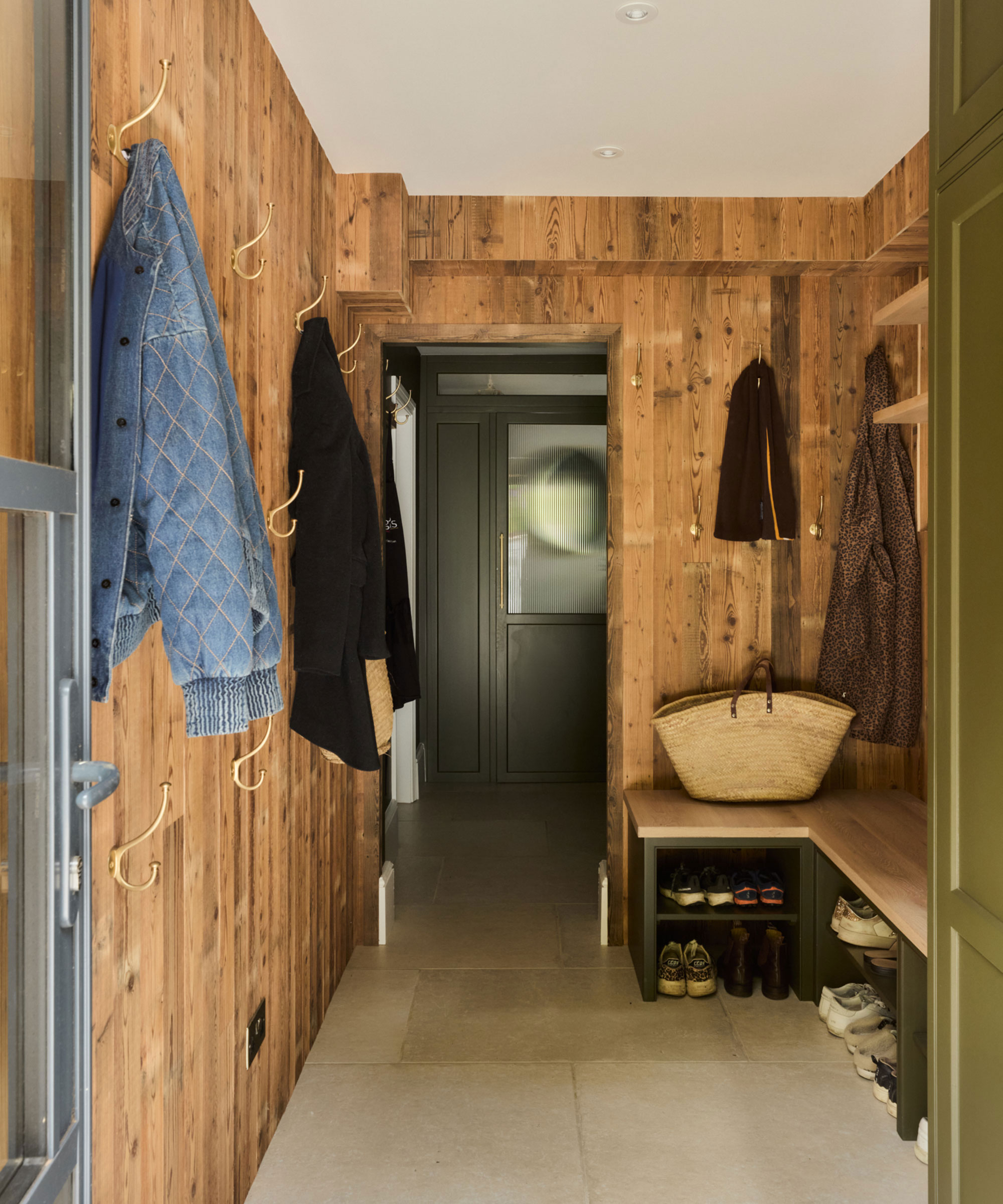 timber clad small boot room with bench seating