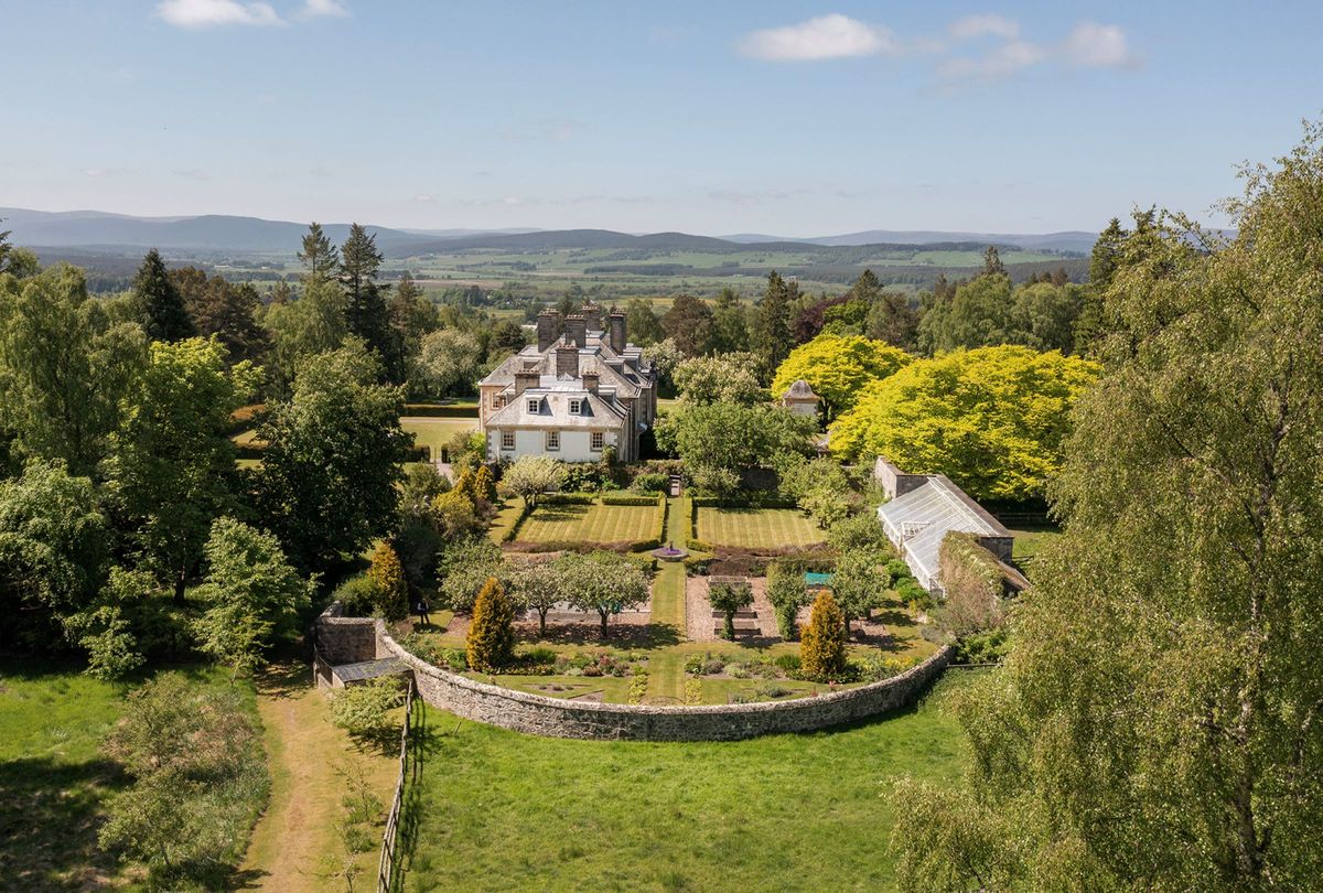 The overhead shot of the house shows an orchard next to the home