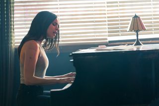 Sofia Carson as Cassie playing the piano and singing