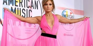 Jennifer Lopez wearing a bright pink dress