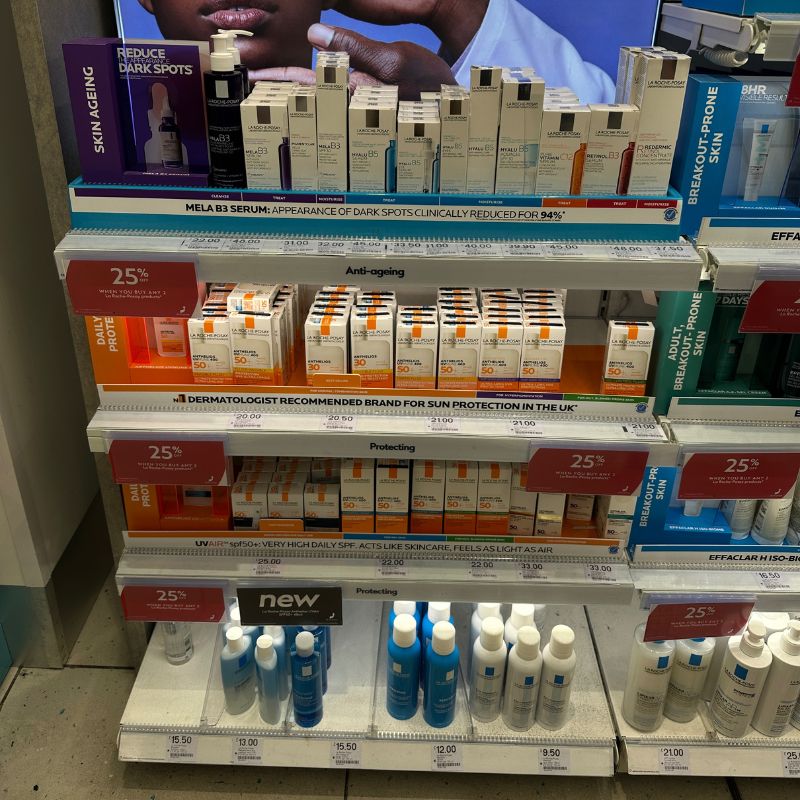 a shelf filled with pharmacy skincare products