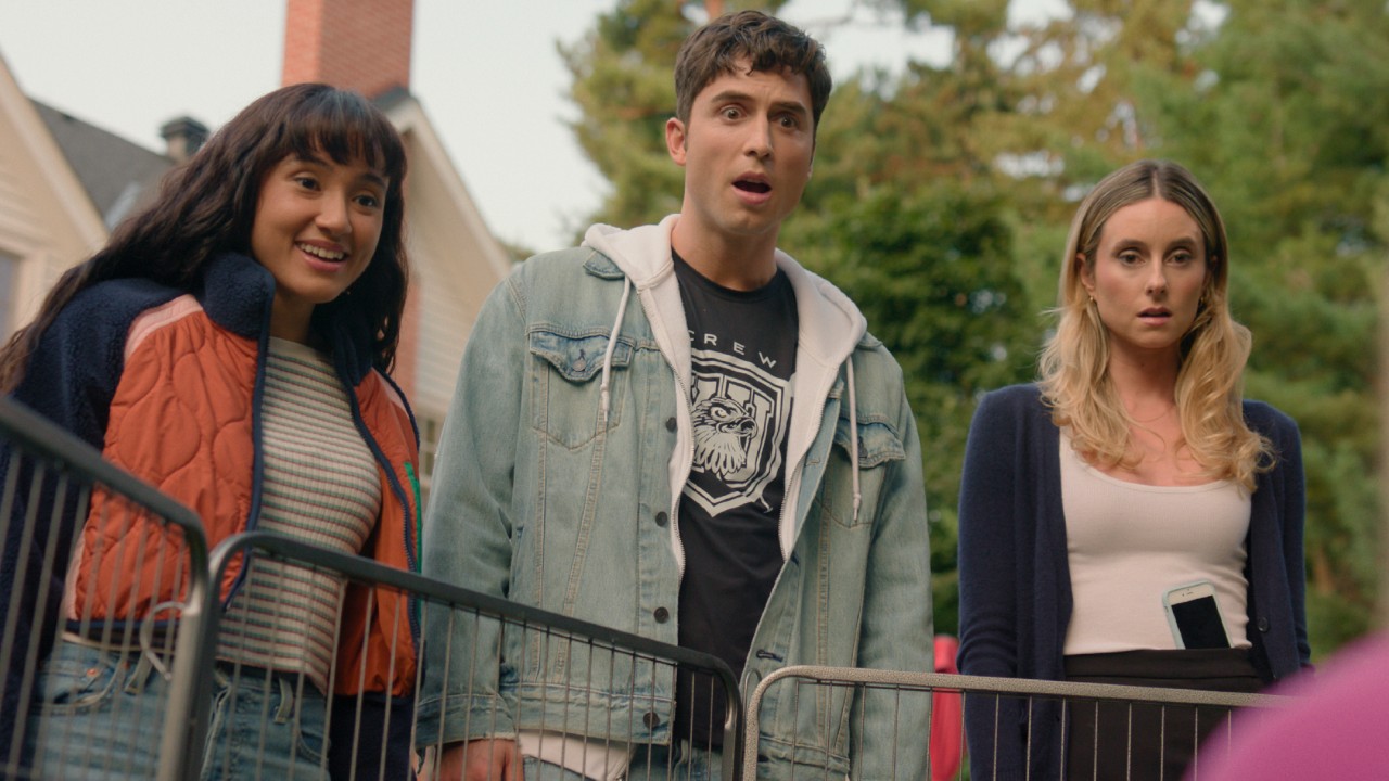 From left to right: Wally Baram smiling, Benito Skinner looking shocked and Mary Beth Barone looking shocked as they all look down at something. 