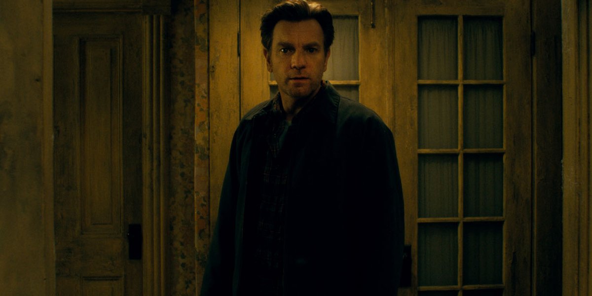 Doctor Sleep Ewan McGregor standing in the rotting halls of The Overlook