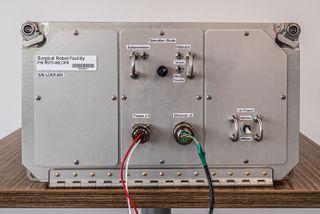 a silver box with knobs on it and wires extending from it with buttons reading "autonomous," "power" and "ethernet"