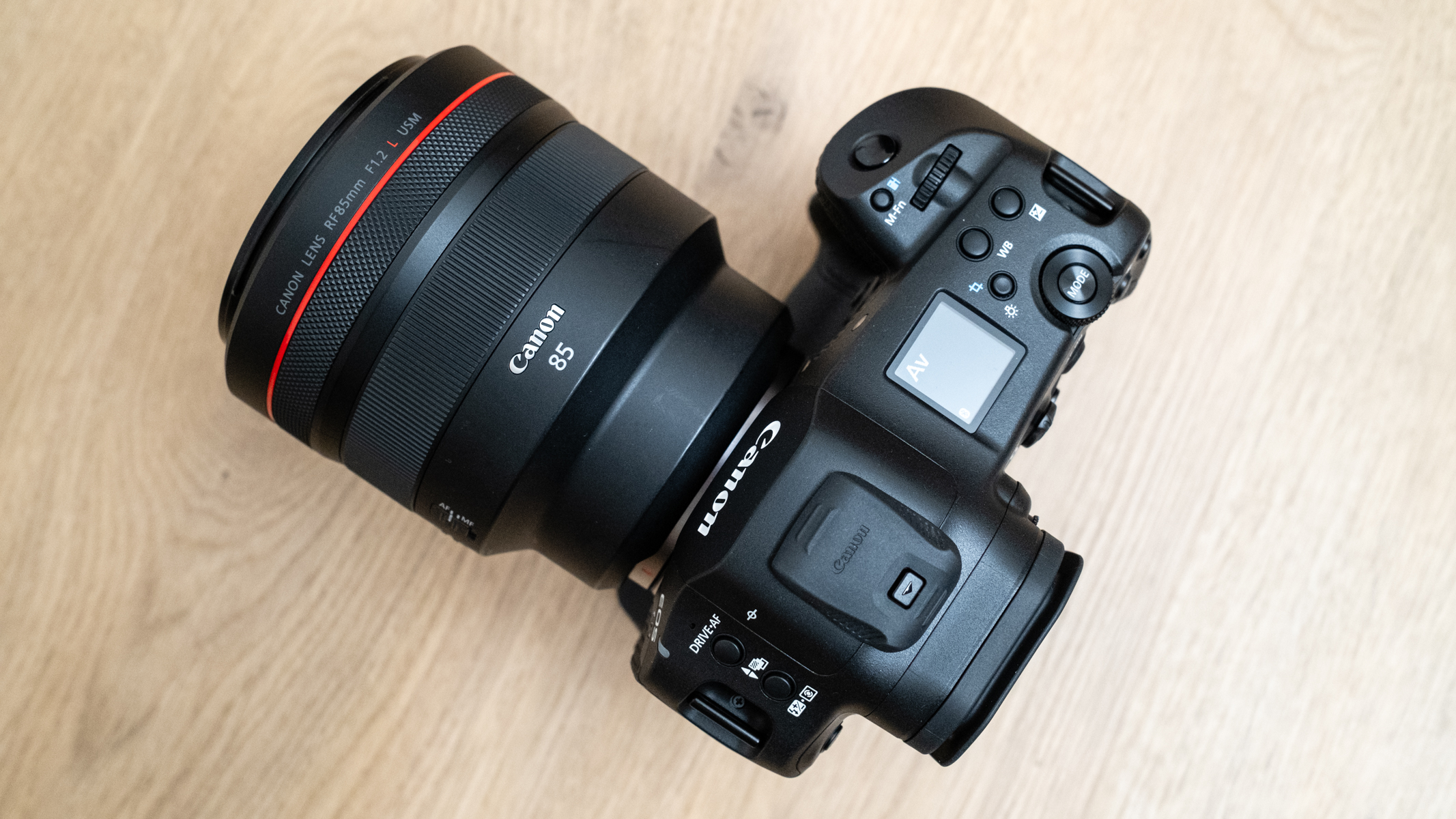 Canon RF 85mm f/1.2L USM attached to a Canon EOS R1 on a wood floor
