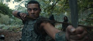 Arondir fires a bow in The Rings of Power season 2