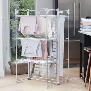 Dry:Soon Deluxe 3-Tier Heated Airer in room with washing hanging, and washing folded on side