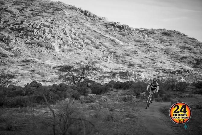 A lone rider gets some shaded relief from record setting high temperatures while navigating a ribbon smooth piece of singletrack before the final descent