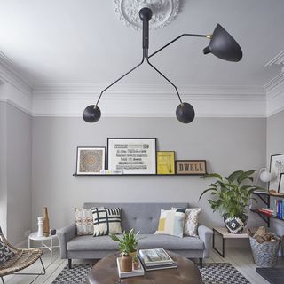 living room with sofa set and photo frame on wall