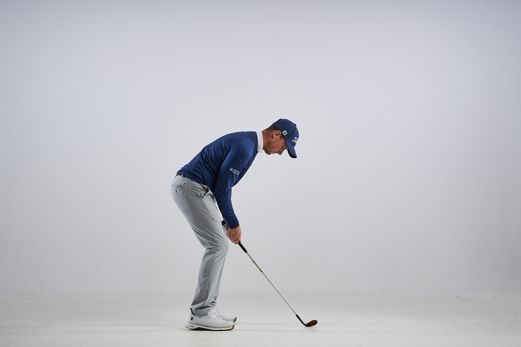 Alex Buckner hunched over the ball in a posture that leads to chunking chip shots