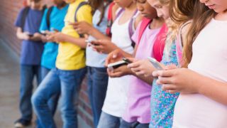 Kids using mobile phone at the elementary school