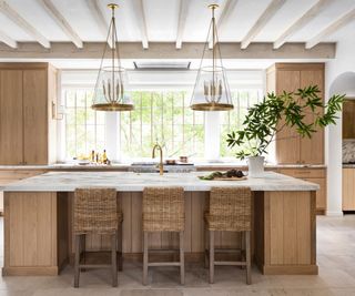 Wooden kitchen with white marble countertops and rustic fixtures