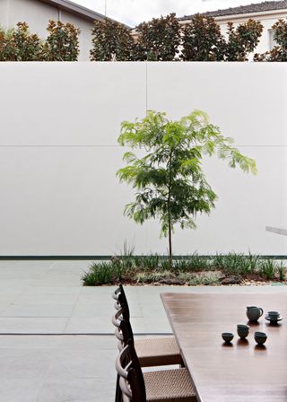 A dining area that opens out onto a garden space