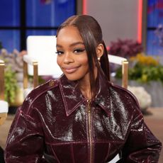 a black woman with brown hair pictured on a talk show set