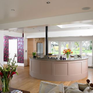 kitchen area with round kitchen counter and wooden floor