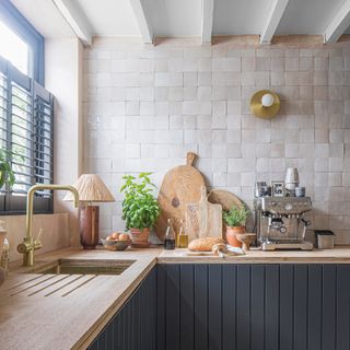 Dark grey modern kitchen with pale worktop and boho style zellige tiled wall