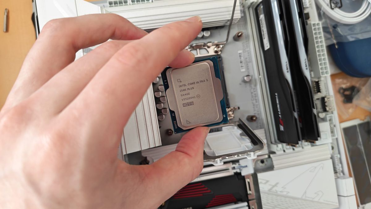 A reviewer placing the Intel Core Ultra 5 250K Plus on its motherboard socket