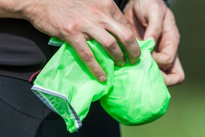 Endura rain jacket being stuffed into small stuff sack