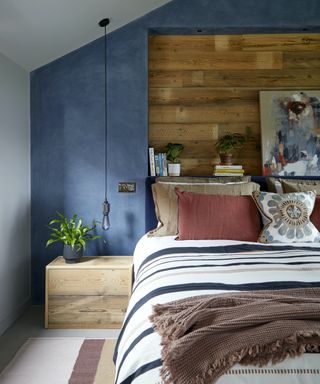 blue bedroom with timber wall cladding