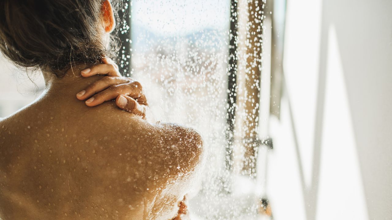 back view of woman taking shower