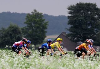 LIEGE BELGIUM AUGUST 14 A general view of Chloe Dygert of The United States and Team CanyonSRAM Racing Amber Kraak of The Netherlands and Team FDJ SUEZ Demi Vollering of The Netherlands and Team SD Worx Protime Yellow leader jersey and the peloton passing through a landscape during the 3rd Tour de France Femmes 2024 Stage 4 a 1227km stage from Valkenburg to Liege UCIWWT on August 14 2024 in Liege Belgium Photo by Dario BelingheriGetty Images