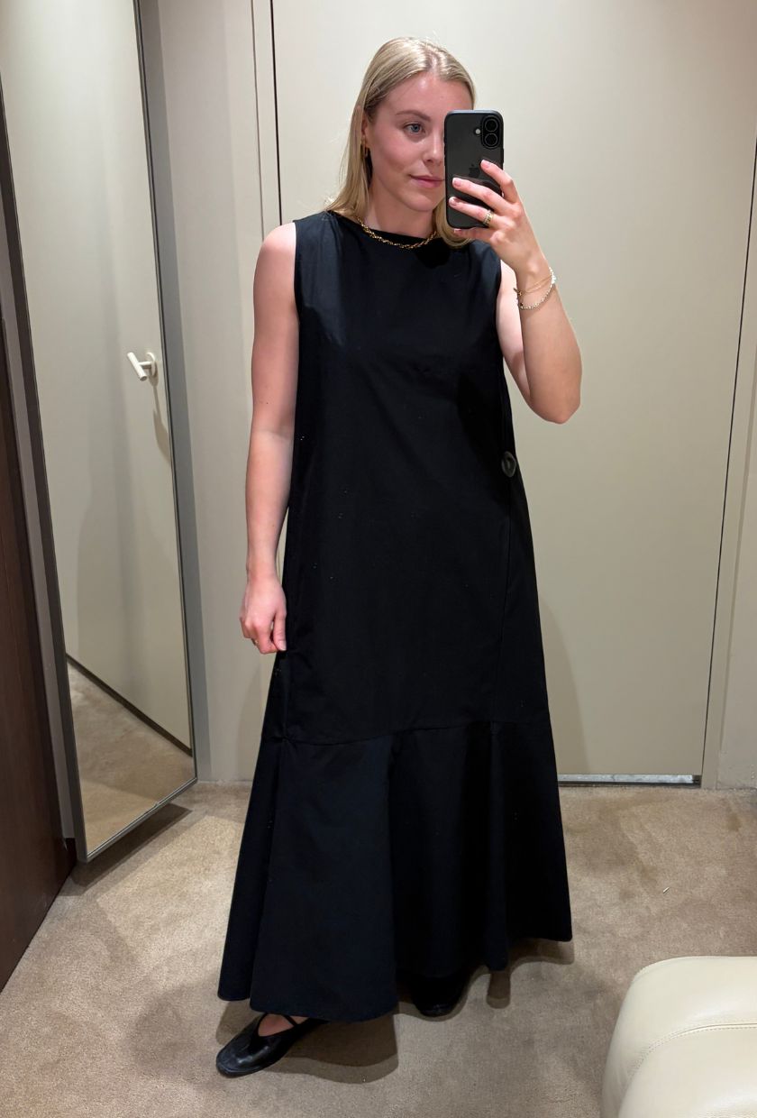 Woman wears black maxi dress, ballet flats