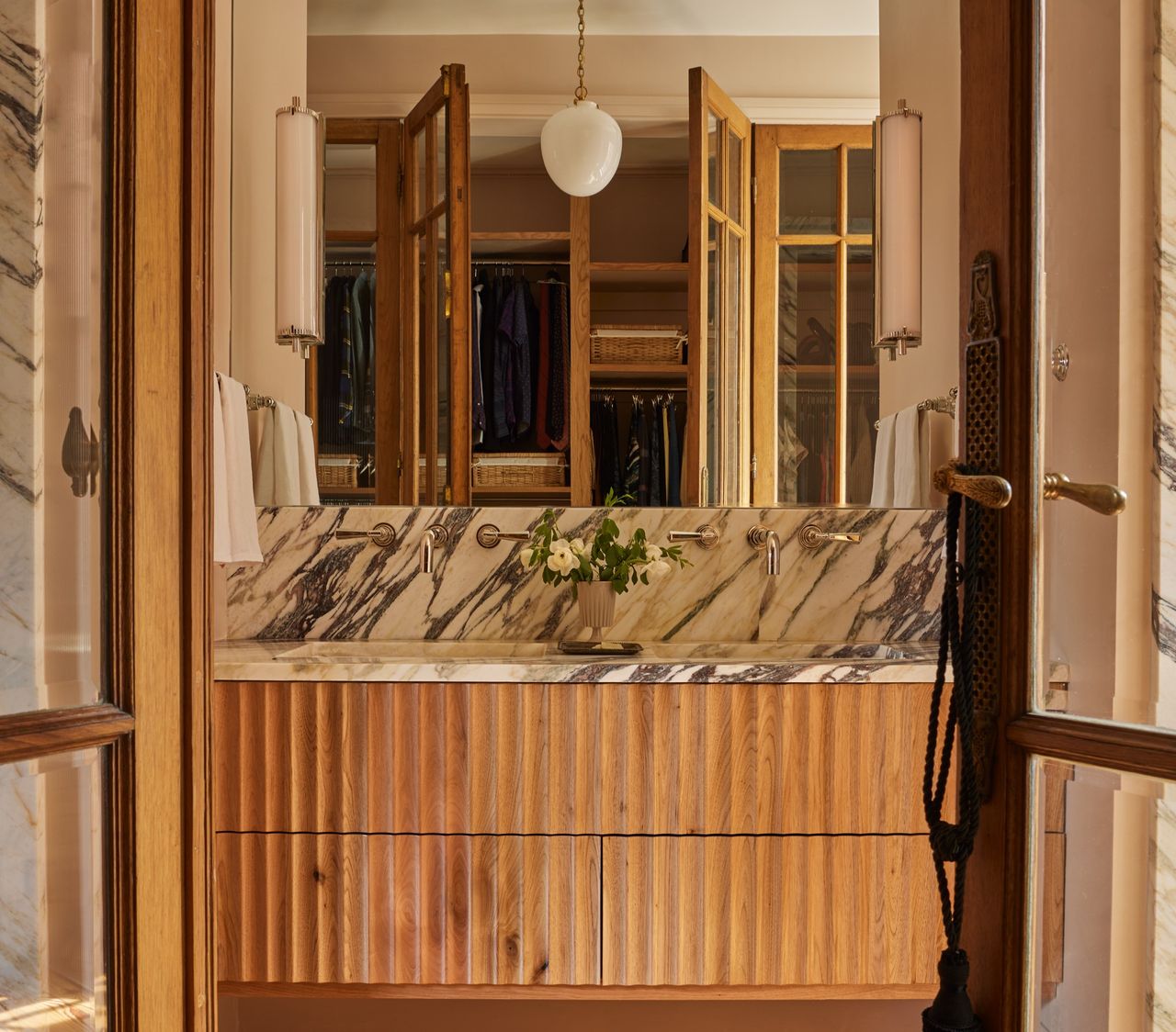 A bathroom with a vanity in ribbed design