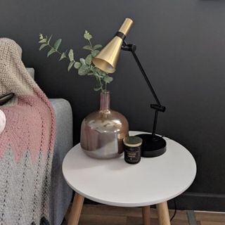 room with black wall and sidetable and table lamp