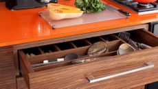 Wood venner unit, utensils drawer, orange laminate worktop