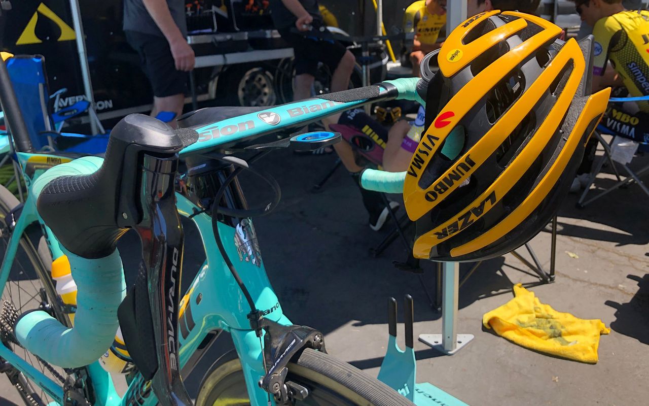 George Bennett and his Jumbo-Visma teammates race with yellow helmets while teammate Primoz Roglic currently wears a pink one in Italy
