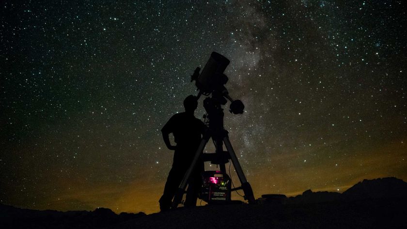 Astronomer using telescope to observe the night sky