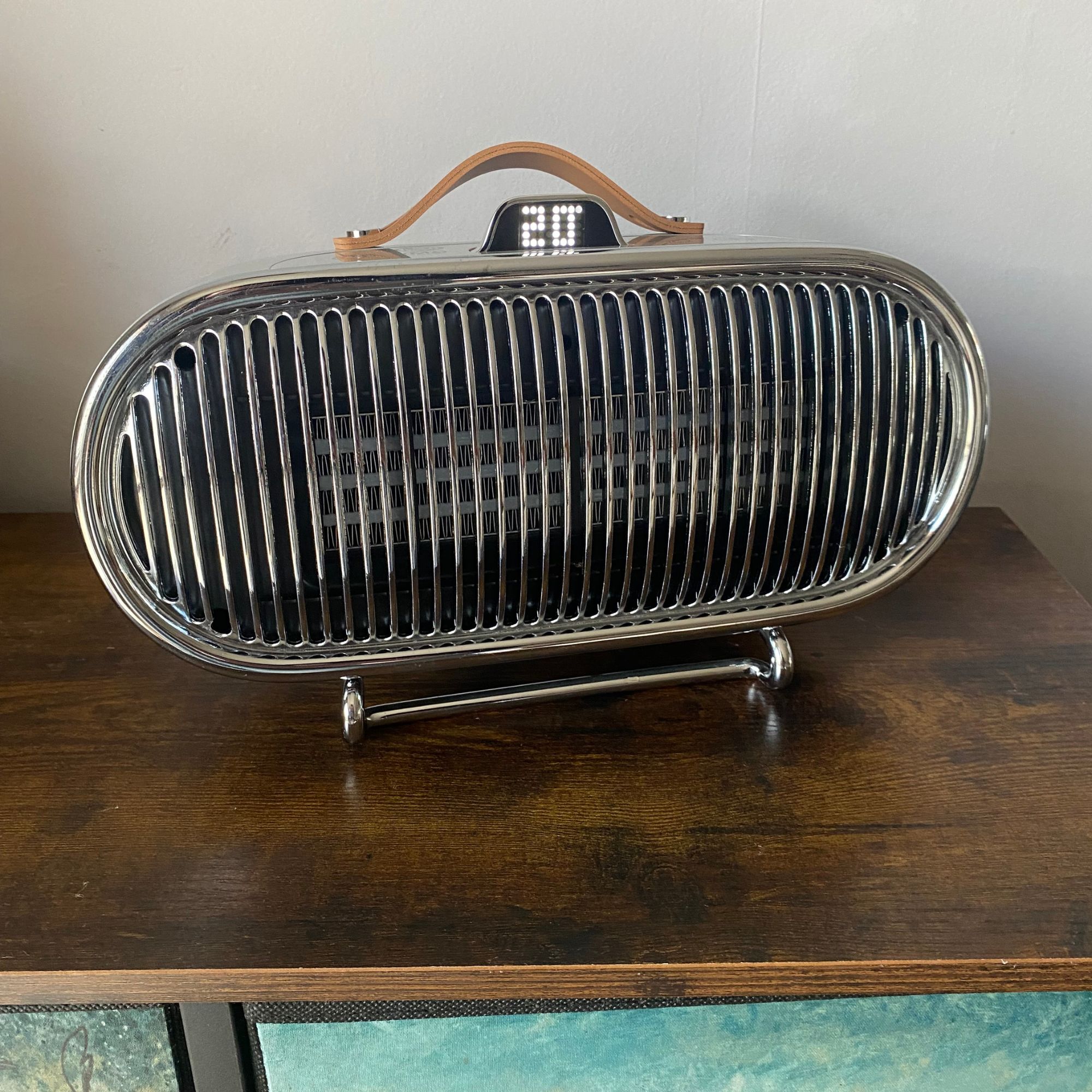 Swan 1.5kW Retro Ceramic Heater sitting on a sideboard with the display screen showing 20 degrees ambient temperature