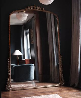 A black living room with a large mirror