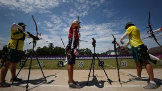 TOKYO, JAPAN - JULY 23: (L to R) Ryan Tyack of Team Australia, Jacob Wukie of Team United States, and David Barnes of Team Australia compete in the Men's Individual Ranking Round during the Tokyo 2020 Olympic Games at Yumenoshima Park Archery Field on July 23, 2021 in Tokyo, Japan.