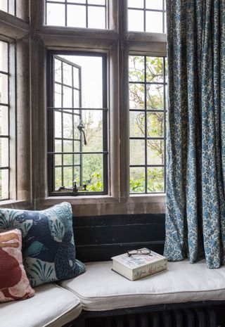 window seat in Mitfords former schoolroom, now a bedroom with Mitfords letters book by open window