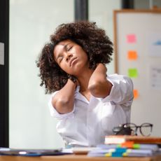 Desk exercise: A woman stretching at her desk