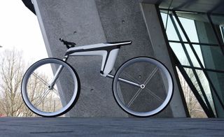 Futuristic bike with white and black frame and no pedals