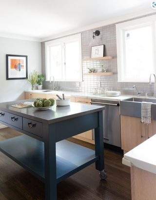Small wooden kitchen with navy blue portable kitchen island