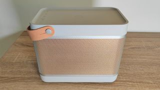 Bang & Olufsen Beolit 20 review: speaker from head-on placed on a brown table