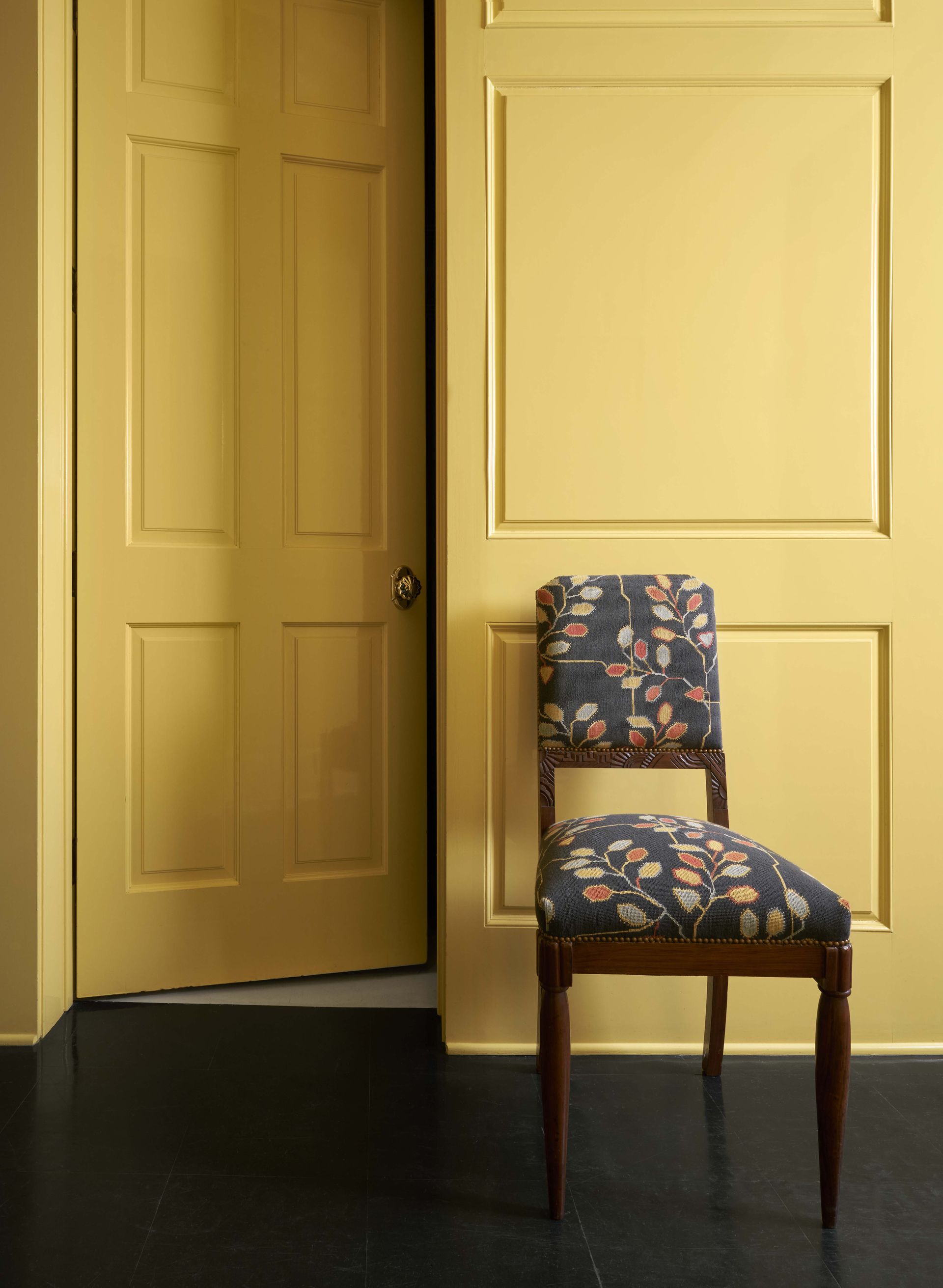 Yellow wall with chair in front