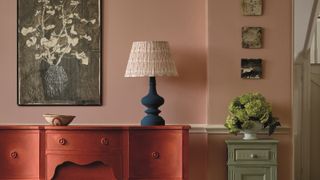 Pink entryway, red console, blue lamp