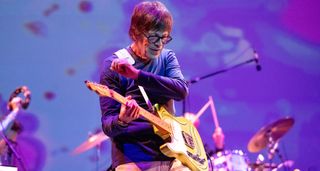 Elliot Easton plays his custard yellow Tele on a stage lit up in purple.