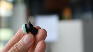 Google Pixel Buds Pro 2 held in a hand 